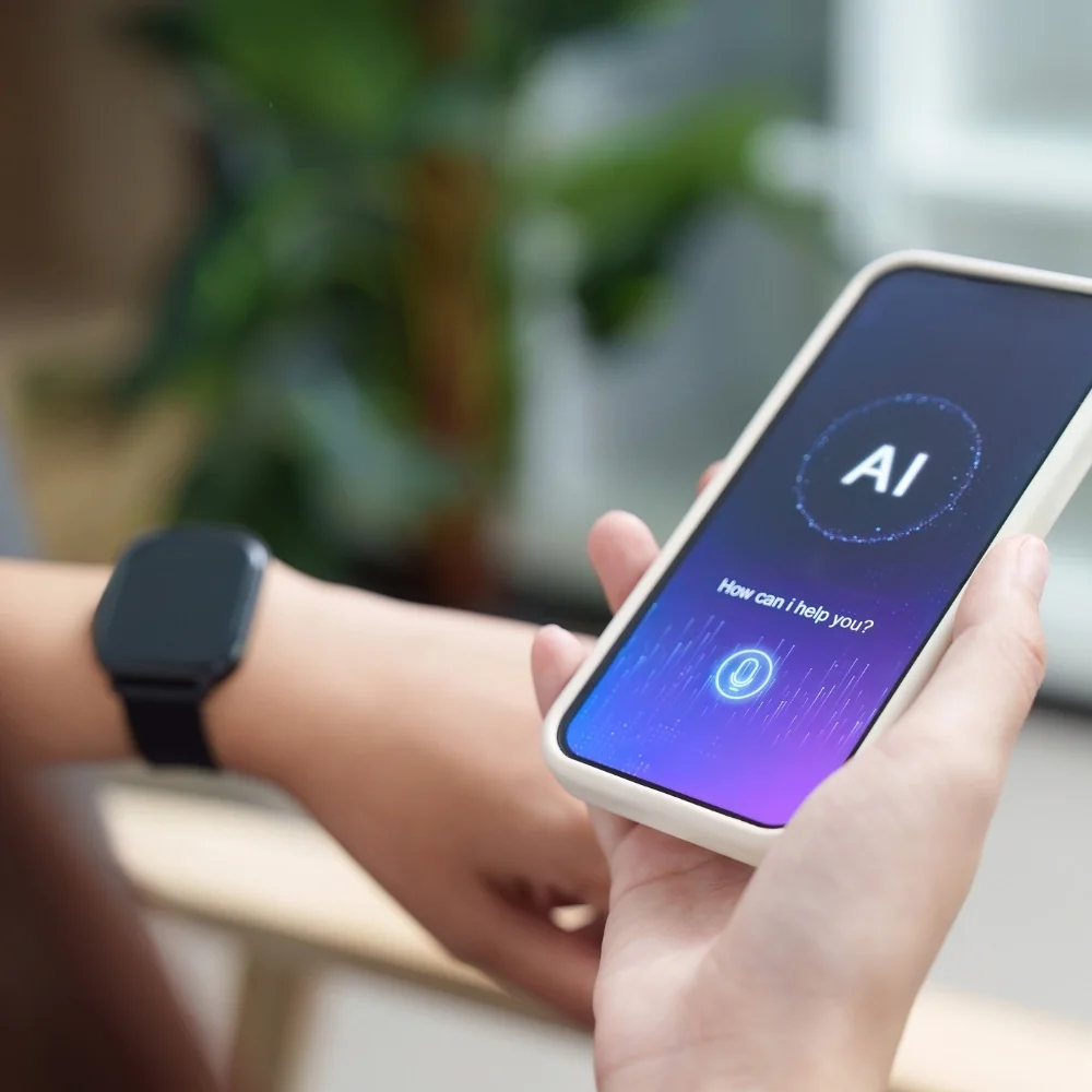 Hand holding a phone screen showing an AI assistant interface