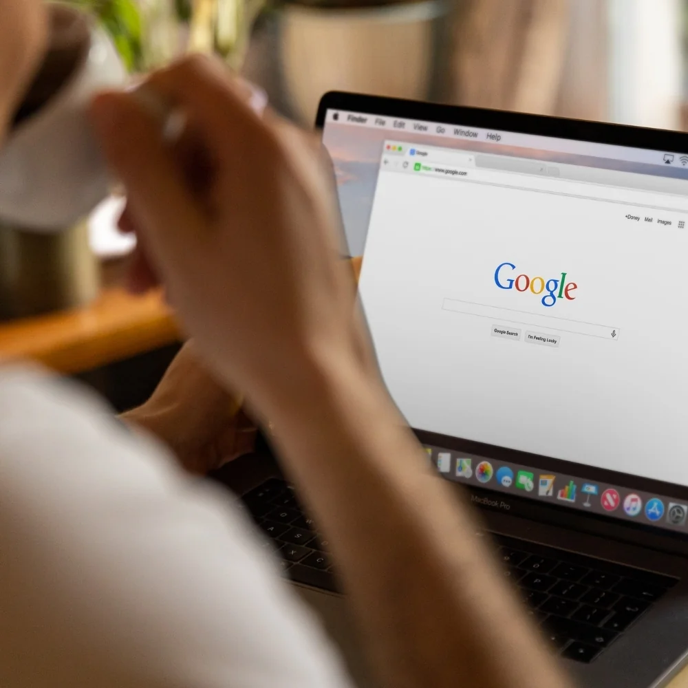 Person using a laptop with a search page open for SEO research